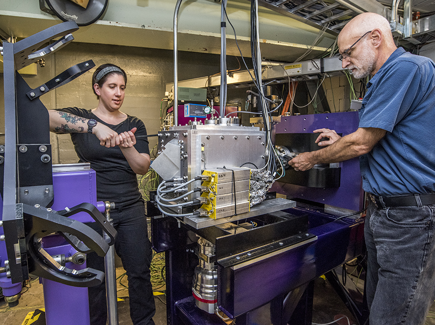 Berkeley Lab Scientists Jacklyn Gates and Kenneth Gregorich work on FIONA at Lawrence Berkeley National Laboratory.