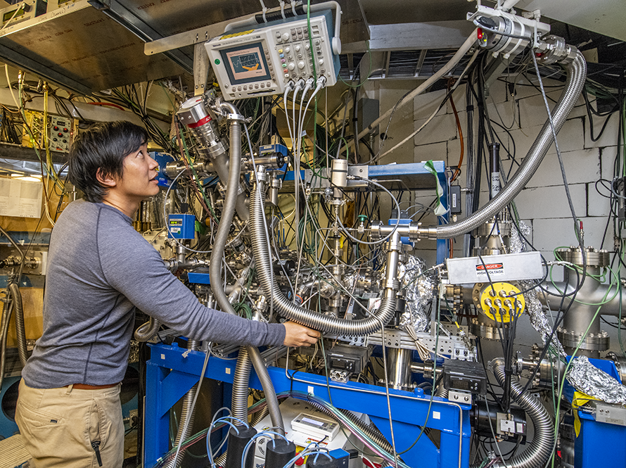 Heavy Element Science researcher adjusts equipment.