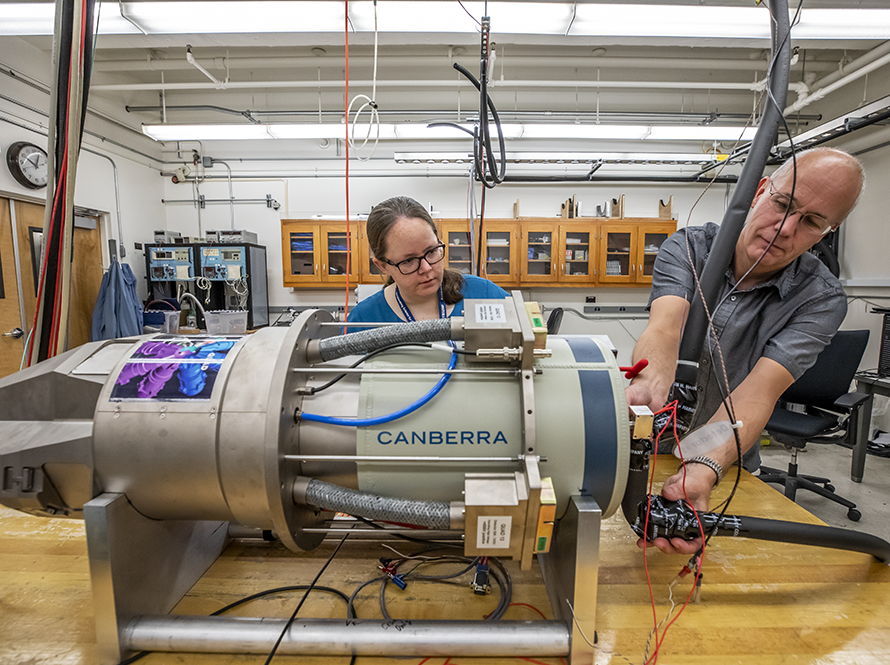 Nuclear Structure researchers adjust equipment.