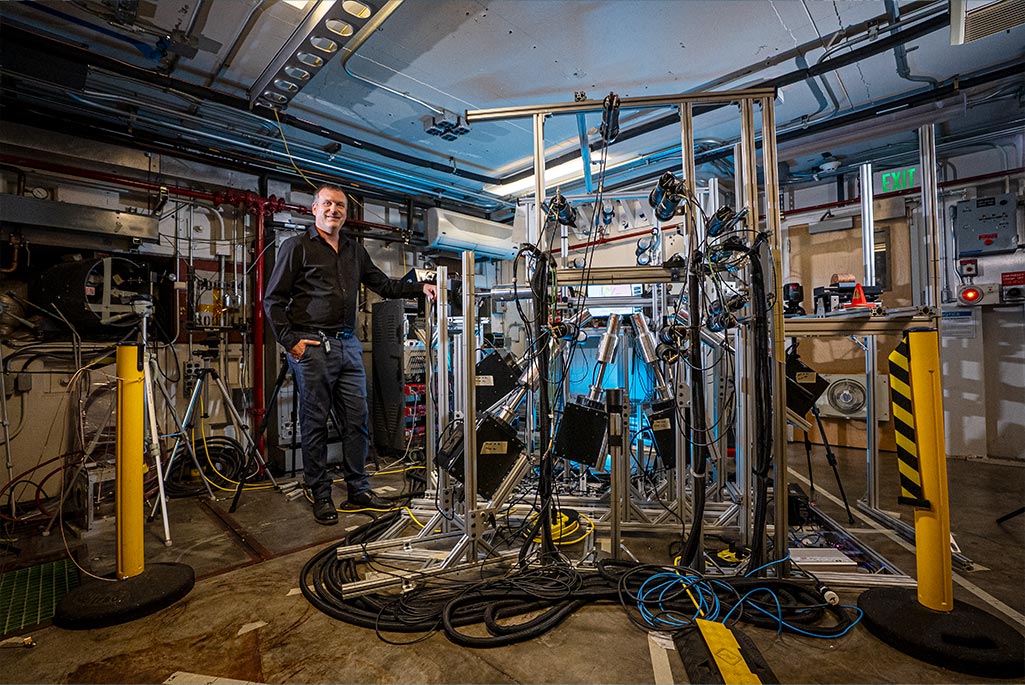 Person standing next to lab equipment
