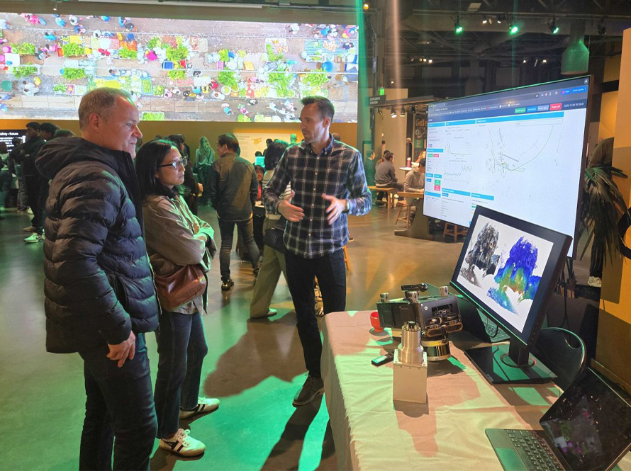 3 people standing in front of multiple displays showing radiation imaging technologies.