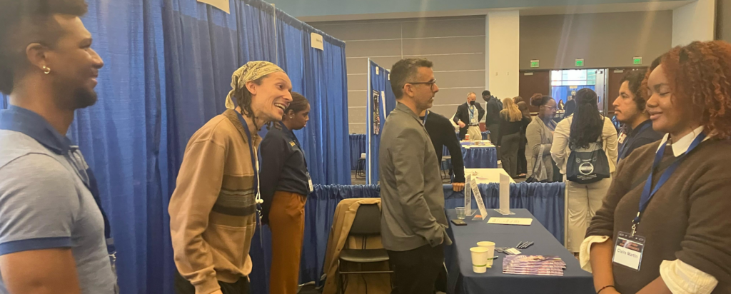 A group of young people speaking to a scientist.