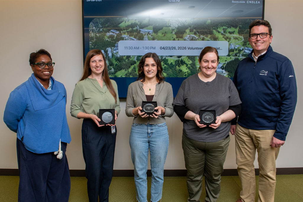 A group of people standing holding awards.